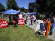 People mill through Vancouver USA Pride on Saturday, exploring booths and carrying rainbow flags. The event, a celebration of the local LGBT community, is hosted by Saturday in the Park Pride every year.