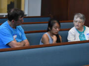 Salmon Creek: Thuy Nguyen, center, reads a book about Harriet Tubman with assistance from Greg Berry, left, and Sandie Hollister, volunteers with the Salmon Creek United Methodist Church’s Project Transformation summer reading program.