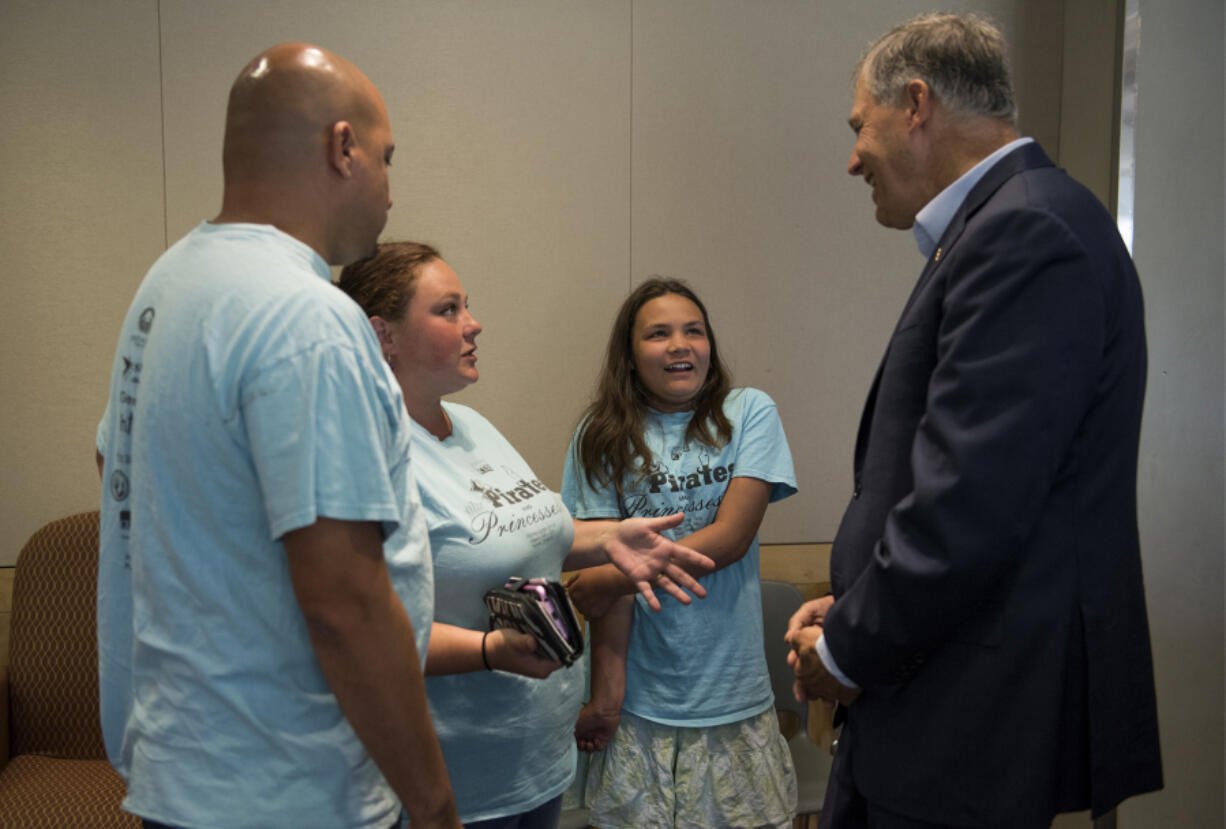 Gov. Jay Inslee, right, talks with Isabella Peiffer, 13, second from right, and her stepmom, Sandy, and dad, George, during Inslee’s Tuesday visit to Legacy Salmon Creek Medical Center. The Longview family was one of three Southwest Washington families to share their stories with the governor during a roundtable discussion about the Medicaid program.