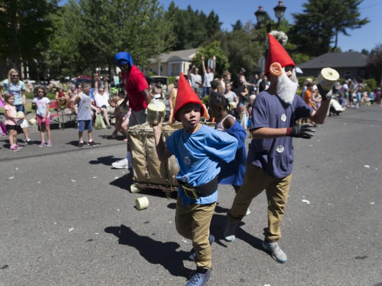 Dwarfs, part of the Georgia-Pacific grand prize-winning float, handed out rolls of toilet paper during the annual Camas Days Grand Parade that was celebrating the theme “Once Upon a Time” on Saturday. (Photos by Randy L.