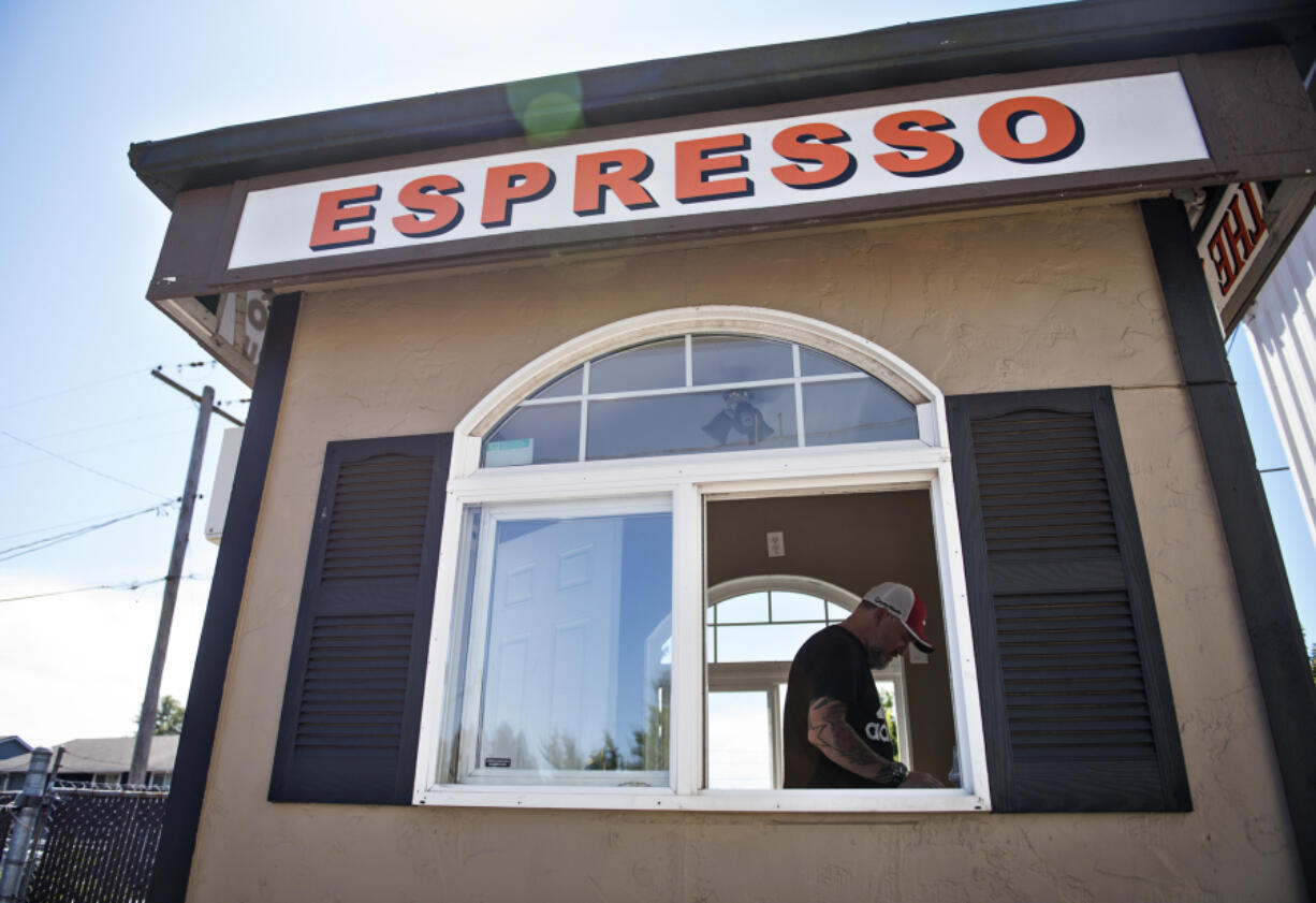 Kleen Street Recovery co-founder Joseph Wild-Talbott fixes up a coffee stand outside their cafe and community club in Vancouver on Wednesday. The organization hopes to have the stand up and running this summer, providing jobs for people in their program and raising funds to put back into Kleen Street Recovery’s programs.