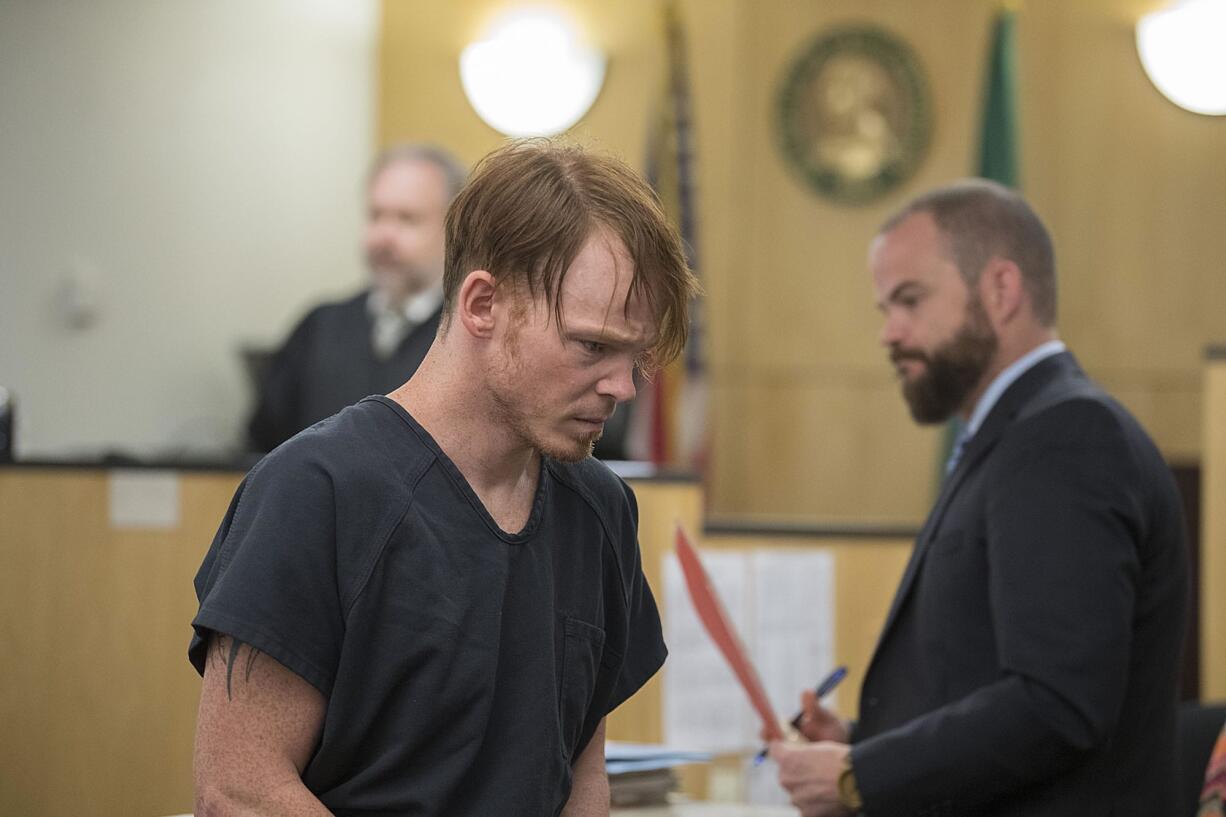 Clark County Corrections Deputy Christopher A. North, foreground, who was arrested Wednesday for alleged sexual misconduct with a female inmate at the Clark County Jail, leaves the courtroom after making a first appearance in Superior Court on Thursday morning, July 27, 2017.