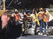 A crew from Lakeside Industries paves Southeast Norelius Drive at the intersection of Southeast 150th Avenue on Wednesday. The work is part of a new effort by Vancouver to repair failing residential streets.