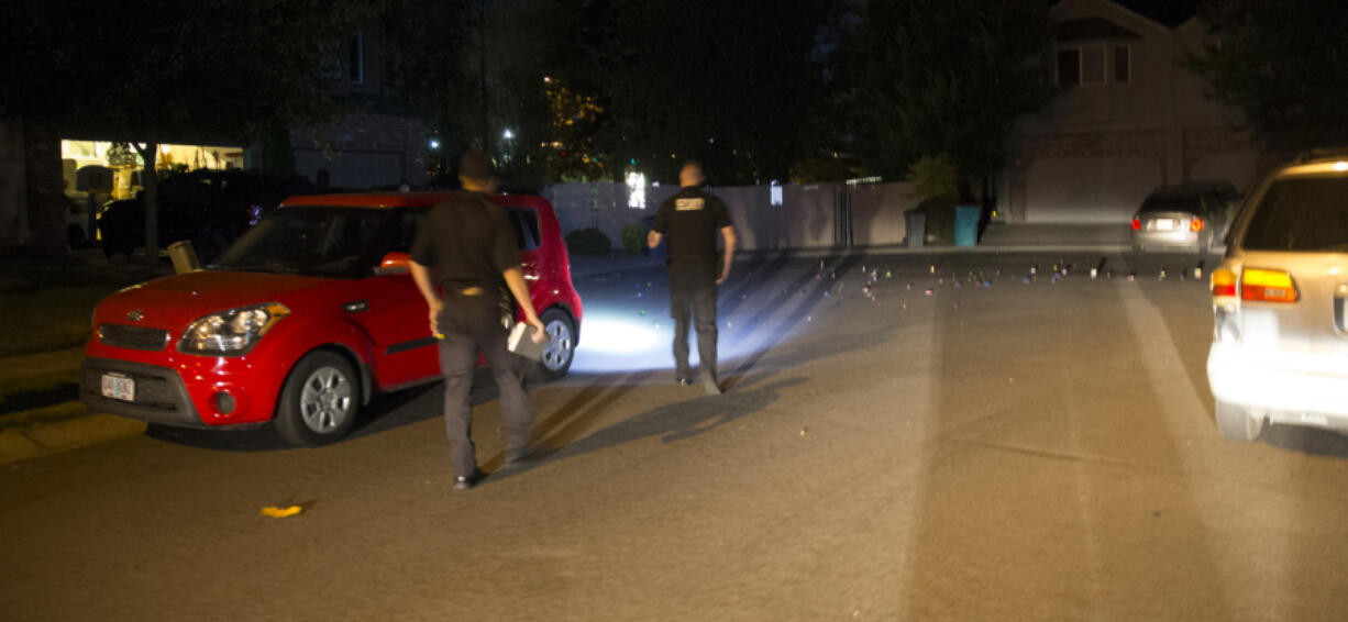 Vancouver Deputy Fire Marshal Cristian Ganea, left, and Sgt. Ryan Wilson of Metro Watch approach a home in Northeast Vancouver where fireworks were being used Sunday in violation of the city’s ban. Photo by Randy L.