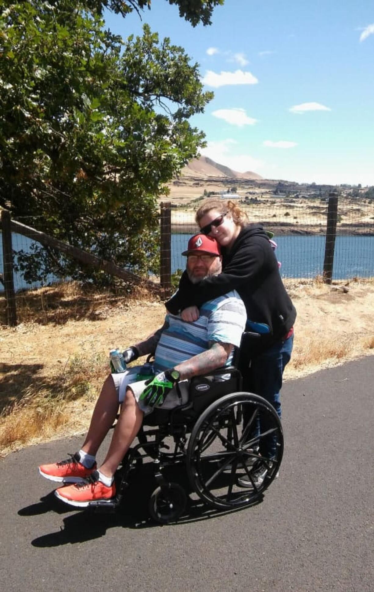 Jeff Bounds gets a hug from his daughter, Rebecca, during a trip to the Columbia Gorge Discovery Center and Museum in The Dalles, Ore., in 2016.