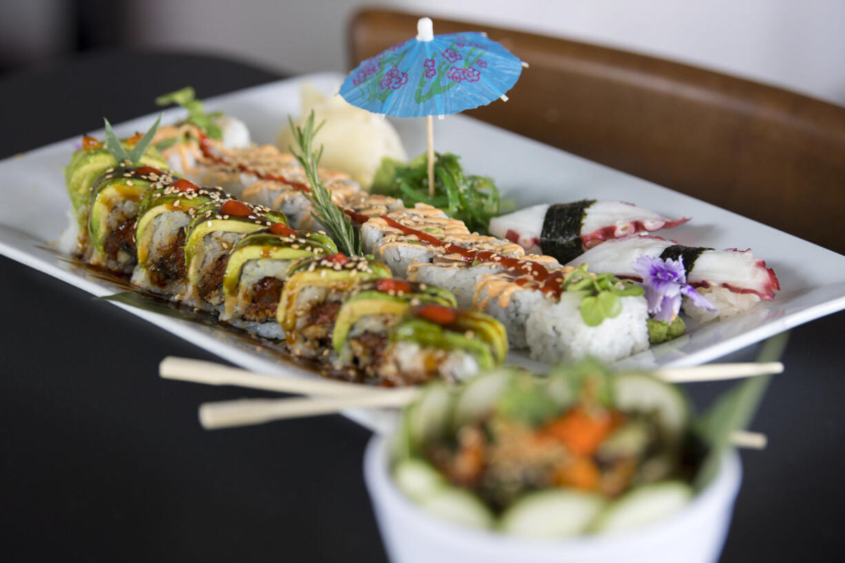 A Camas caterpillar roll, from left, is served with a spicy salmon roll and tako (octopus) at The Sushi Joint in Camas.