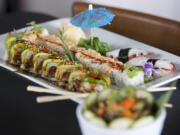 A Camas caterpillar roll, from left, is served with a spicy salmon roll and tako (octopus) at The Sushi Joint in Camas.