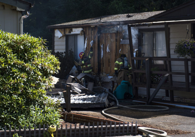 Officials work the scene of a fire in two mobile homes at Green Mountains Mobile Ranch on Tuesday afternoon.