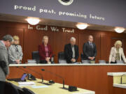 Members of the Clark County council pray before a meeting, which they’ve done for the past four years.