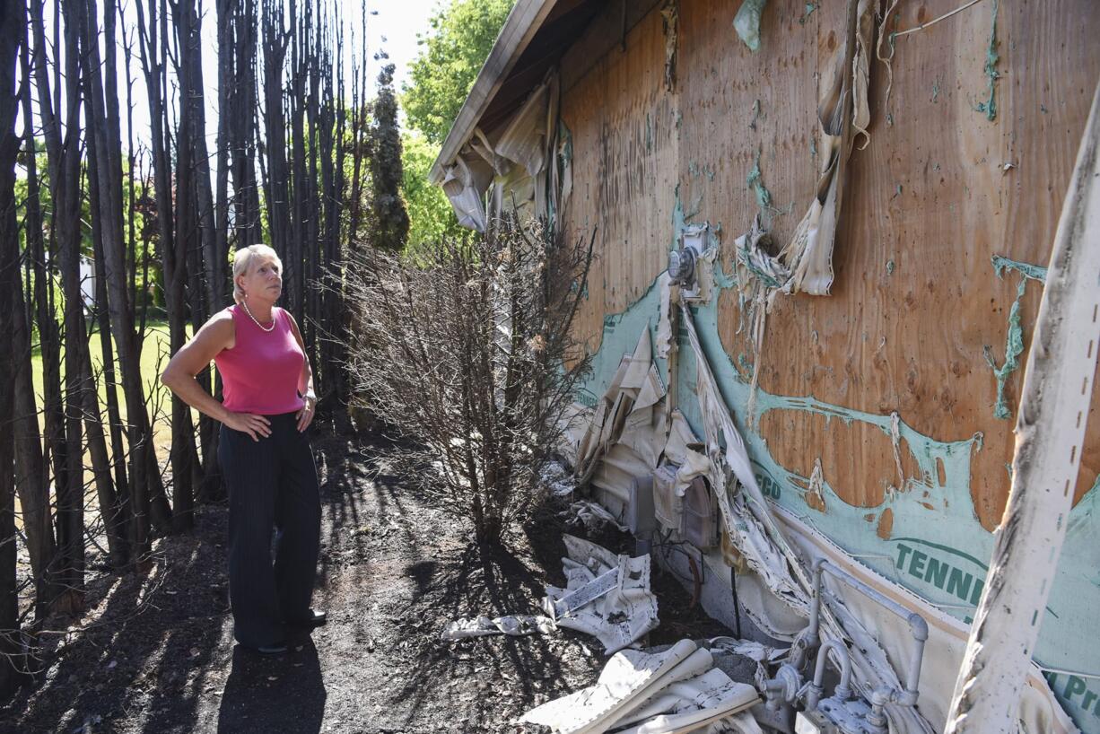Clark County Councilor Julie Olson has had better Fourth of July holidays. Olson gazes at the damage left by a fire that broke out early morning July 5. She and the fire marshal suspect a smoldering firework was to blame.
