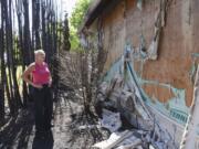 Clark County Councilor Julie Olson has had better Fourth of July holidays. Olson gazes at the damage left by a fire that broke out early morning July 5. She and the fire marshal suspect a smoldering firework was to blame.