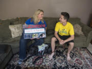 Darsi Ross of Vancouver, left, and her son, Anthony, 15, who has Type 1 diabetes, are joined by his 2-year-old service dog, Gracie, in their Vancouver home. Anthony was diagnosed with Type 1 diabetes when he was 3 years old and, later this month, he will travel to Washington, D.C., to advocate for diabetes research.