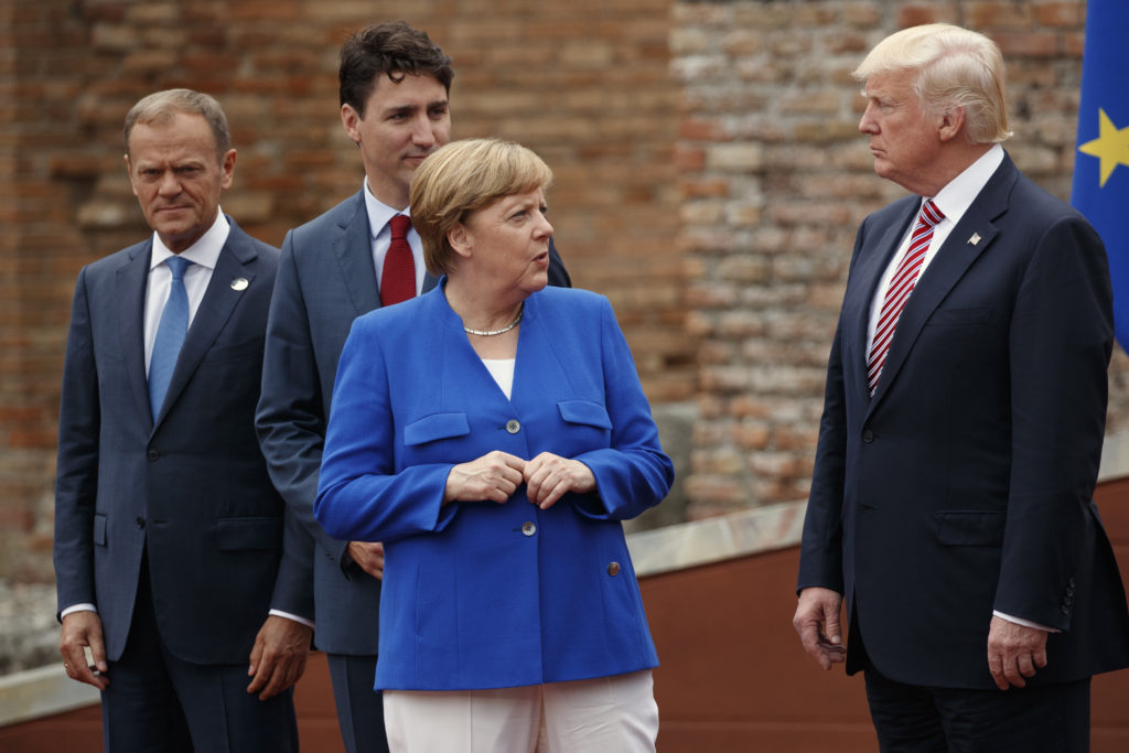 FILE - In this May 26,m 2017 file photo, German Chancellor Angela Merkel, accompanied by European Council President Donald Tusk, Canadian Prime Minister Justin Trudeau, talks with President Donald Trump during a family photo with G7 leaders at the Ancient Greek Theater of Taormina in Taormina, Italy. President Donald Trump will learn this week whether he gets a second chance to make a first impression as he returns to Europe and has his first encounter with Russia’s Vladimir Putin.