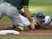 Seattle Mariners' Mitch Haniger, right, is tagged out at third base by Oakland Athletics third baseman Matt Chapman during the third inning of a baseball game, Thursday, July 6, 2017, in Seattle. Haniger was trying to advance after a fly ball hit by Jarrod Dyson was caught by Oakland Athletics center fielder Jaycob Brugman. (AP Photo/Ted S.