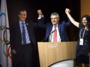 Eric Garcetti, Mayor of Los Angeles, left, International Olympic Committee, IOC, President Thomas Bach, from Germany, center, and Anne Hidalgo, Mayor of Paris, right, pose together during the International Olympic Committee (IOC) Extraordinary Session, at the SwissTech Convention Centre, in Lausanne, Switzerland, Tuesday, July 11, 2017. The IOC has decided it can pick both Los Angeles and Paris as Olympic host cities in September when the 2024 and 2028 Summer Games rights should be awarded simultaneously.