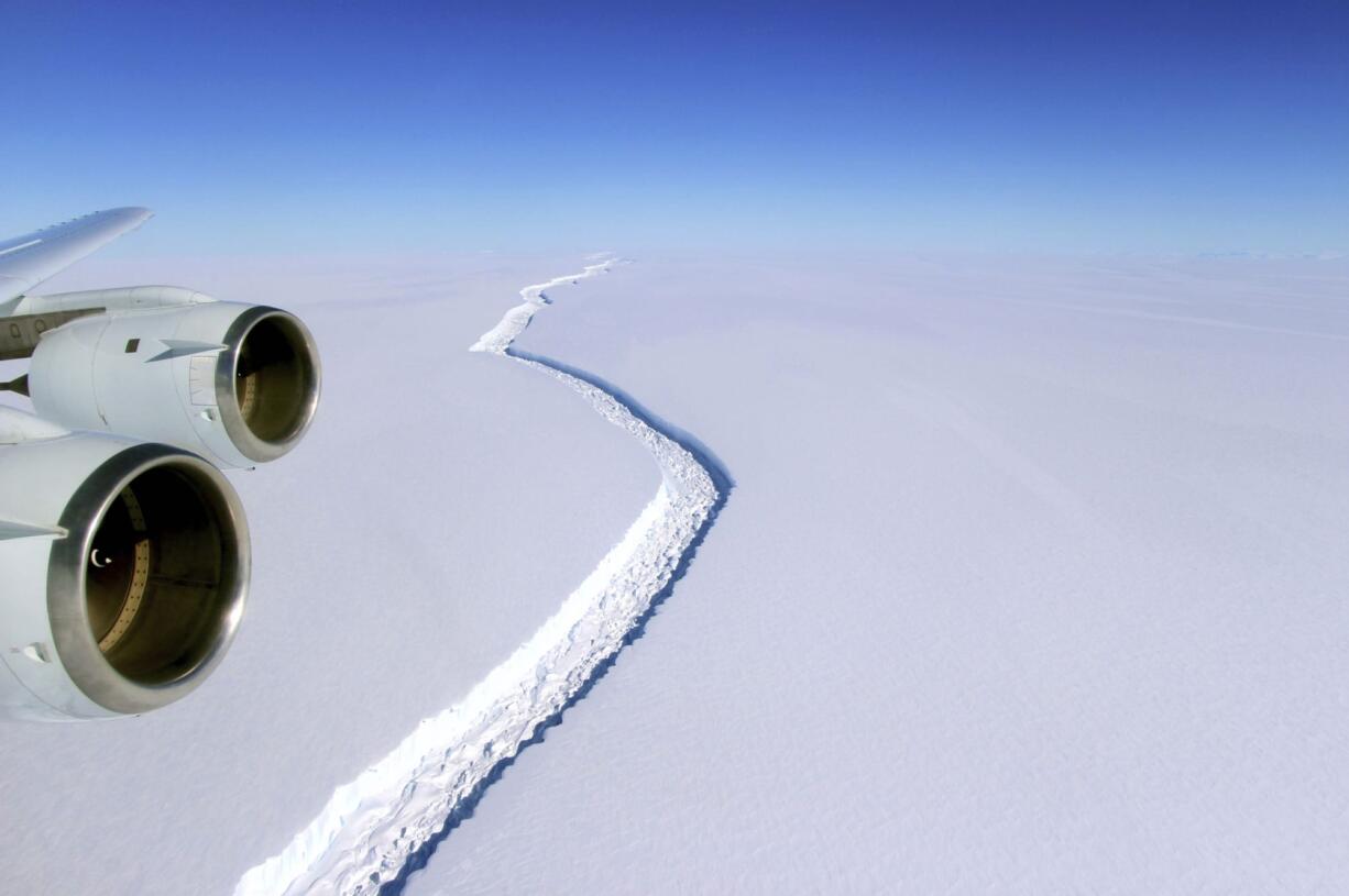 This Nov. 10, 2016 aerial photo released by NASA, shows a rift in the Antarctic Peninsula's Larsen C ice shelf. A vast iceberg with twice the volume of Lake Erie has broken off from a key floating ice shelf in Antarctica, scientists said Wednesday July 12, 2017 . The iceberg broke off from the Larsen C ice shelf, scientists at the University of Swansea in Britain said. The iceberg, which is likely to be named A68, is described as weighing 1 trillion tons (1.12 trillion U.S.