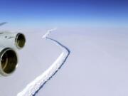 This Nov. 10, 2016 aerial photo released by NASA, shows a rift in the Antarctic Peninsula's Larsen C ice shelf. A vast iceberg with twice the volume of Lake Erie has broken off from a key floating ice shelf in Antarctica, scientists said Wednesday July 12, 2017 . The iceberg broke off from the Larsen C ice shelf, scientists at the University of Swansea in Britain said. The iceberg, which is likely to be named A68, is described as weighing 1 trillion tons (1.12 trillion U.S.