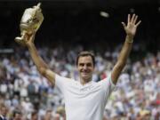 Switzerland's Roger Federer celebrates with the trophy after beating Croatia's Marin Cilic in the Men's Singles final match on day thirteen at the Wimbledon Tennis Championships in London Sunday, July 16, 2017.