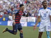 United States’ Dom Dwyer (14) celebrates after scoring a goal as Panama’s Anibal Godoy (20) protests.