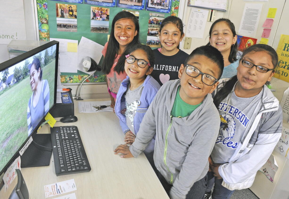 Jefferson Elementary School students, from left, Gladys Espinoza, Anahi Villa, Suri Valles, Samuel Solano, Kimberly Madera and Jizlinn Martinez-Cruz play a video they made about growing up in a bilingual world June 8 in Mount Vernon. The students hope that their stories will inspire others.