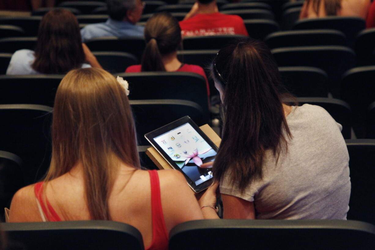 A student looks at her iPad on Aug. 23, 2011, at Burlington High School in Burlington, Mass.