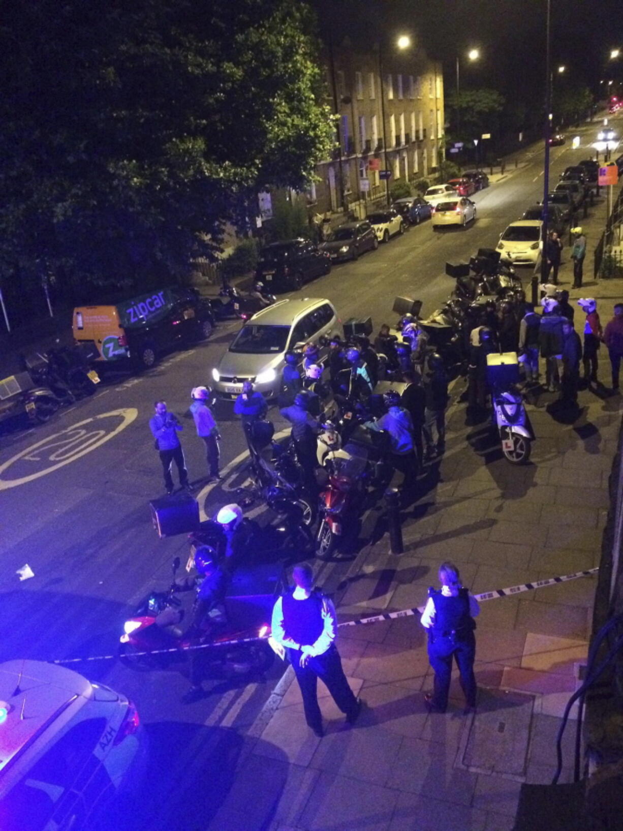 This is an image made available by Sarah Cobbold of the scene of an acid attack in London early Thursday July 13, 2017. Police said that five linked acid attacks by men on mopeds in London have left several people injured -- the latest in a spate of such crimes that have alarmed residents and politicians. The Metropolitan Police force says the 90-minute spree began late Thursday when Two men on a moped tossed a noxious substance into the face of a 32-year-old moped driver, then jumped on his vehicle and drove away.