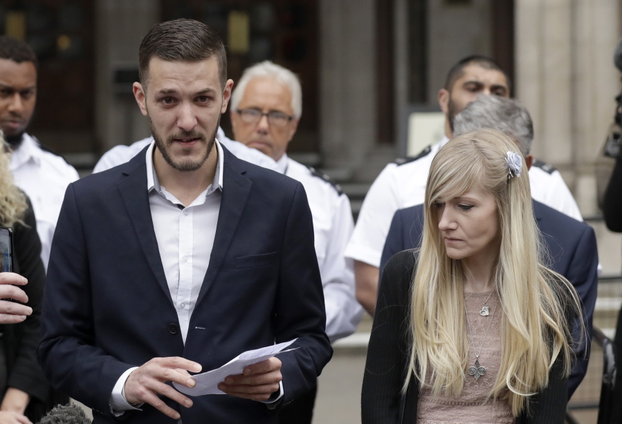 Chris Gard, the father of critically ill baby Charlie Gard finishes reading out a statement next to mother Connie Yates, right, at the end of their case at the High Court in London, Monday, July 24, 2017. The parents of critically ill baby Charlie Gard dropped their legal bid Monday to send him to the United States for an experimental treatment after new medical tests showed that the window of opportunity to help him had closed.