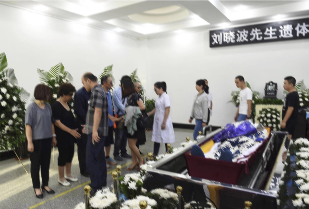 In this photo provided by the Shenyang Municipal Information Office, people attend the of jailed Nobel Peace Prize winner and Chinese dissident Liu Xiaobo during his funeral at a funeral parlor in Shenyang in northeastern China's Liaoning Province, Saturday, July 15, 2017. China says the body of Liu Xiaobo, who died this week after a battle with liver cancer, has been cremated. The government of the city of Shenyang in northeastern China, where Liu was treated, said in a briefing that the cremation took place Saturday morning in a ceremony attended by family and friends.