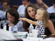 Rep. Jaime Herrera Beutler, R-Battle Ground, holds her daughter, Abigail, during a markup hearing held by the House Appropriations Committee on Wednesday on Capitol Hill. Rep. Martha Roby, R-Ala., is seated next to Herrera Beutler.