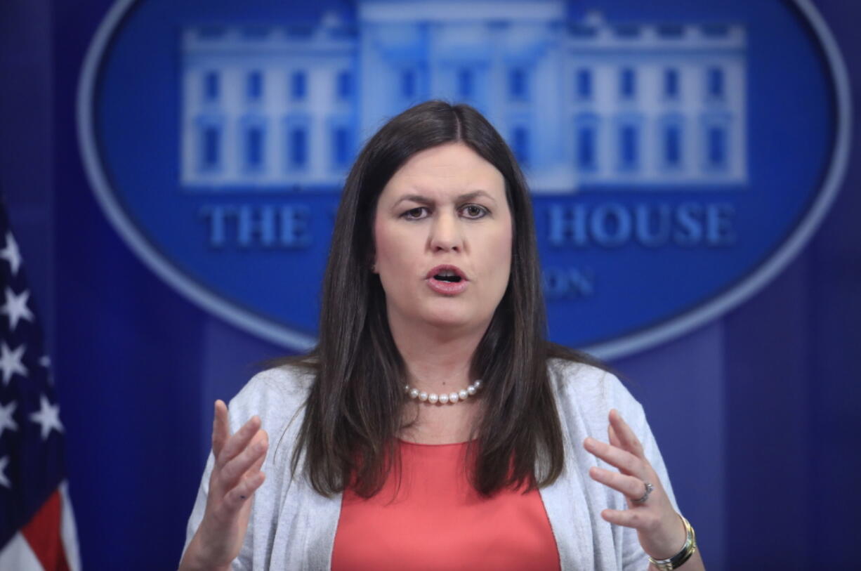 FILE- In this June 30, 2017, file photo, White House deputy press secretary Sarah Huckabee Sanders speaks during the daily press briefing at the White House in Washington. The White House indicated Sunday, July 23, that President Donald Trump would sign a sweeping Russia sanctions measure that requires him to get Congress’ permission before lifting or easing the economic penalties against Moscow.