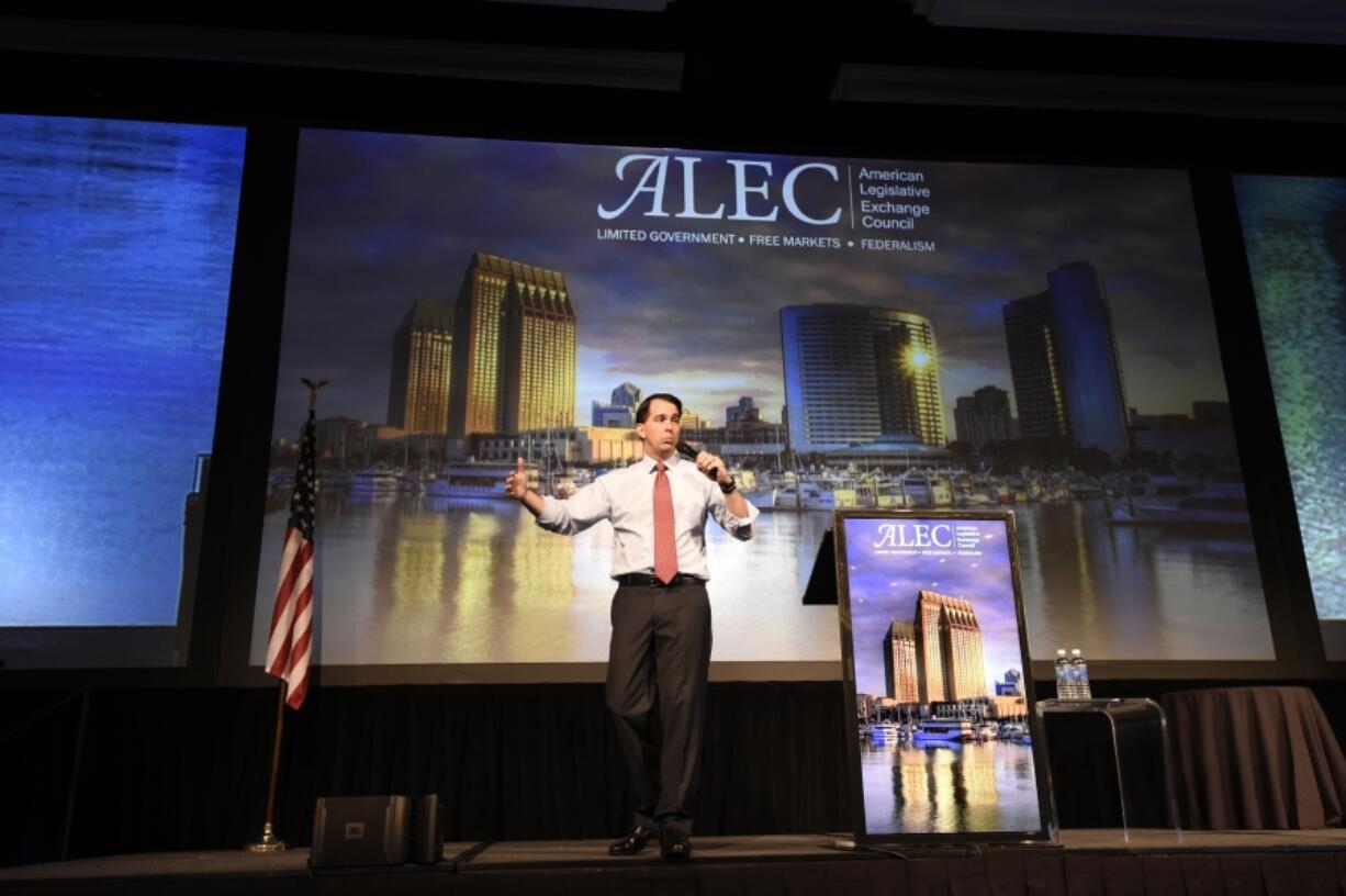 Republican presidential candidate Wisconsin Gov. Scott Walker speaks at the American Legislative Exchange Council 42nd annual meeting in July 2015 in San Diego, Calif. For four decades, the well-funded conservative group, ALEC, has helped write legislation to help sympathetic state lawmakers rein in unions, expand charter schools and limit taxes. Now they’re trying to expand to the final frontiers of government, traditionally nonpartisan city councils, which have become a bastion of liberal resistance to Donald Trump.