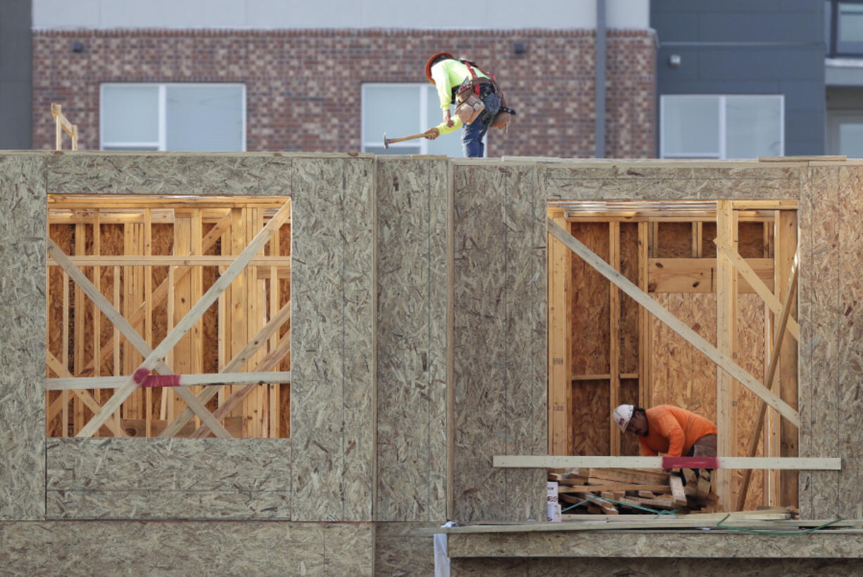 Construction workers build a residential complex July 12, 2017, in Nashville, Tenn. On Friday the Commerce Department reported the U.S. economy picked up steam in the spring, but fell short of President Donald Trump’s optimistic goals.