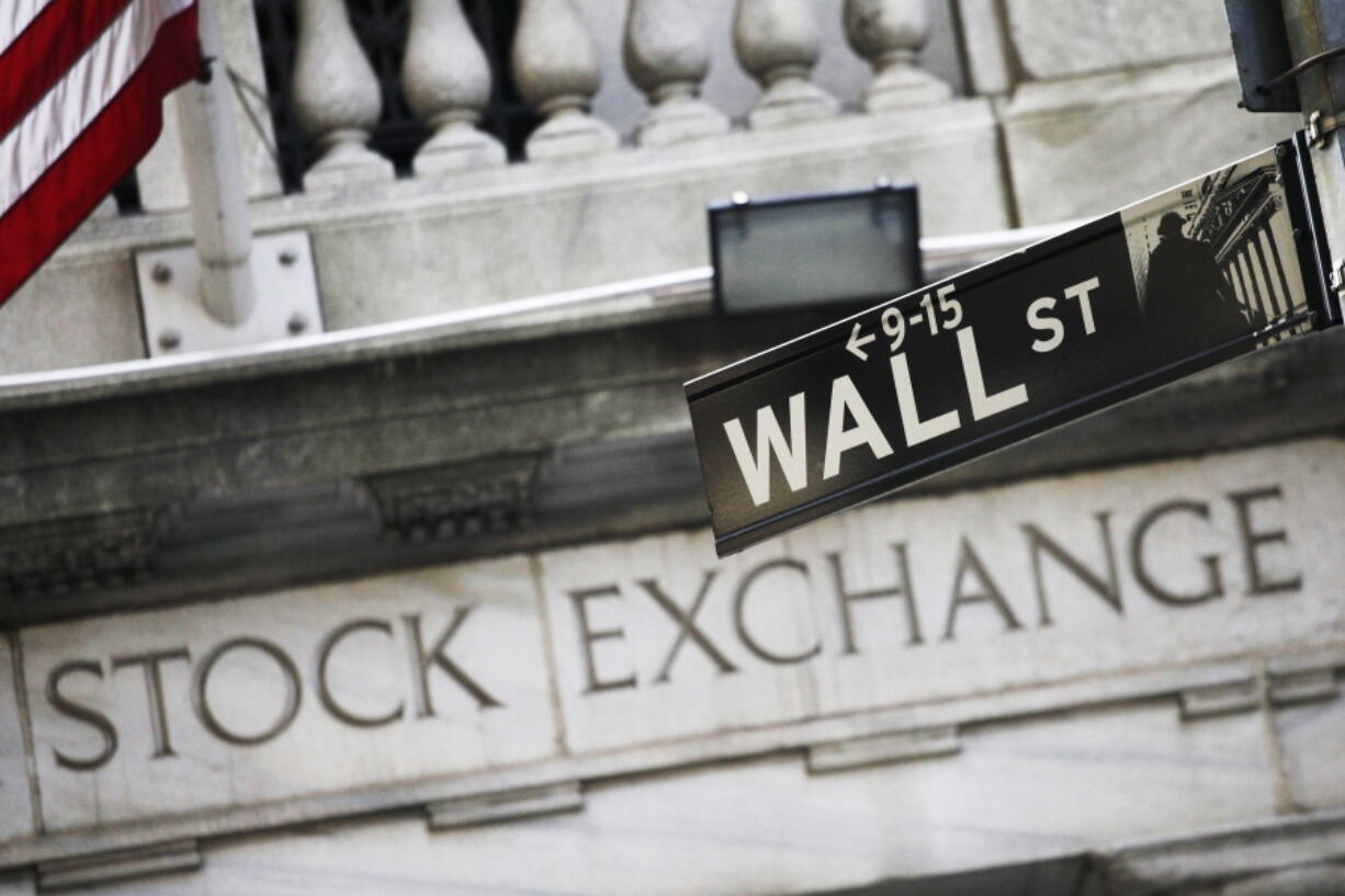 A Wall Street street sign is seen outside the New York Stock Exchange on July 16. U.S. stocks fell slightly Friday as General Electric stock dropped after the company’s second-quarter report. Most other industries are also lower, including technology companies, which have soared during a 10-day winning streak.