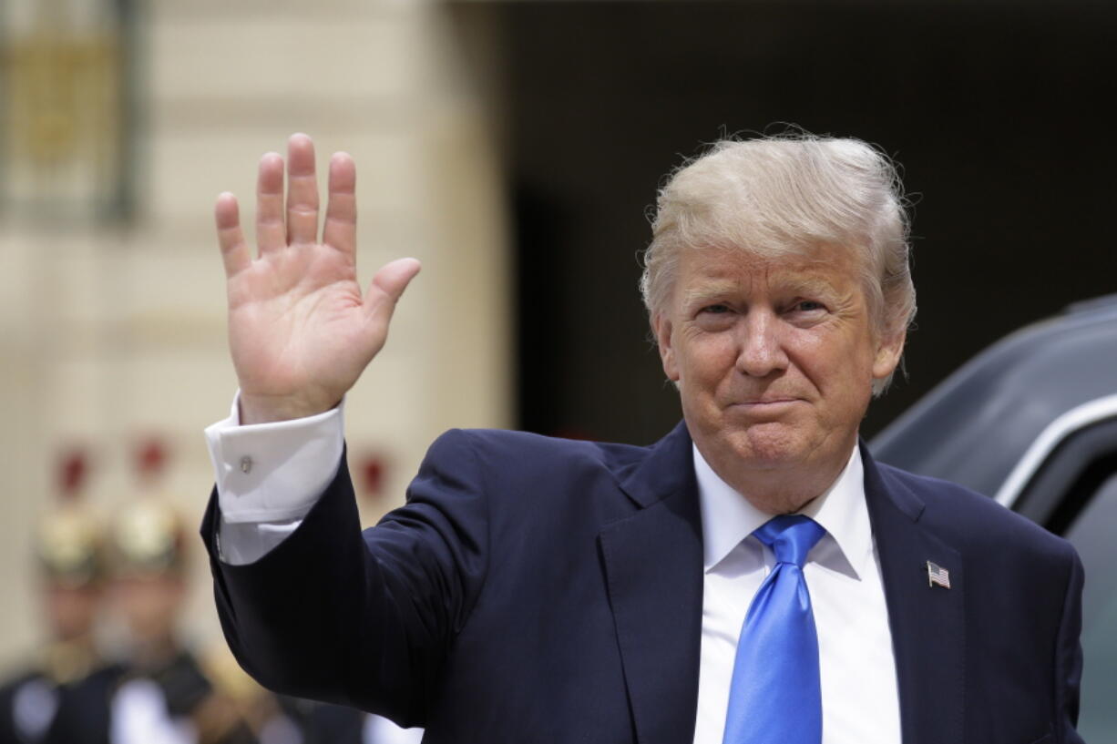 US President Donald Trump waves as he arrives for a meeting with French President Emmanuel Macron at the Elysee Palace in Paris on Thursday. Trump will be the parade’s guest of honor to commemorate the 100th anniversary of the U.S. entry into World War I. U.S. troops will open the parade Friday as is traditional for the guest of honor.