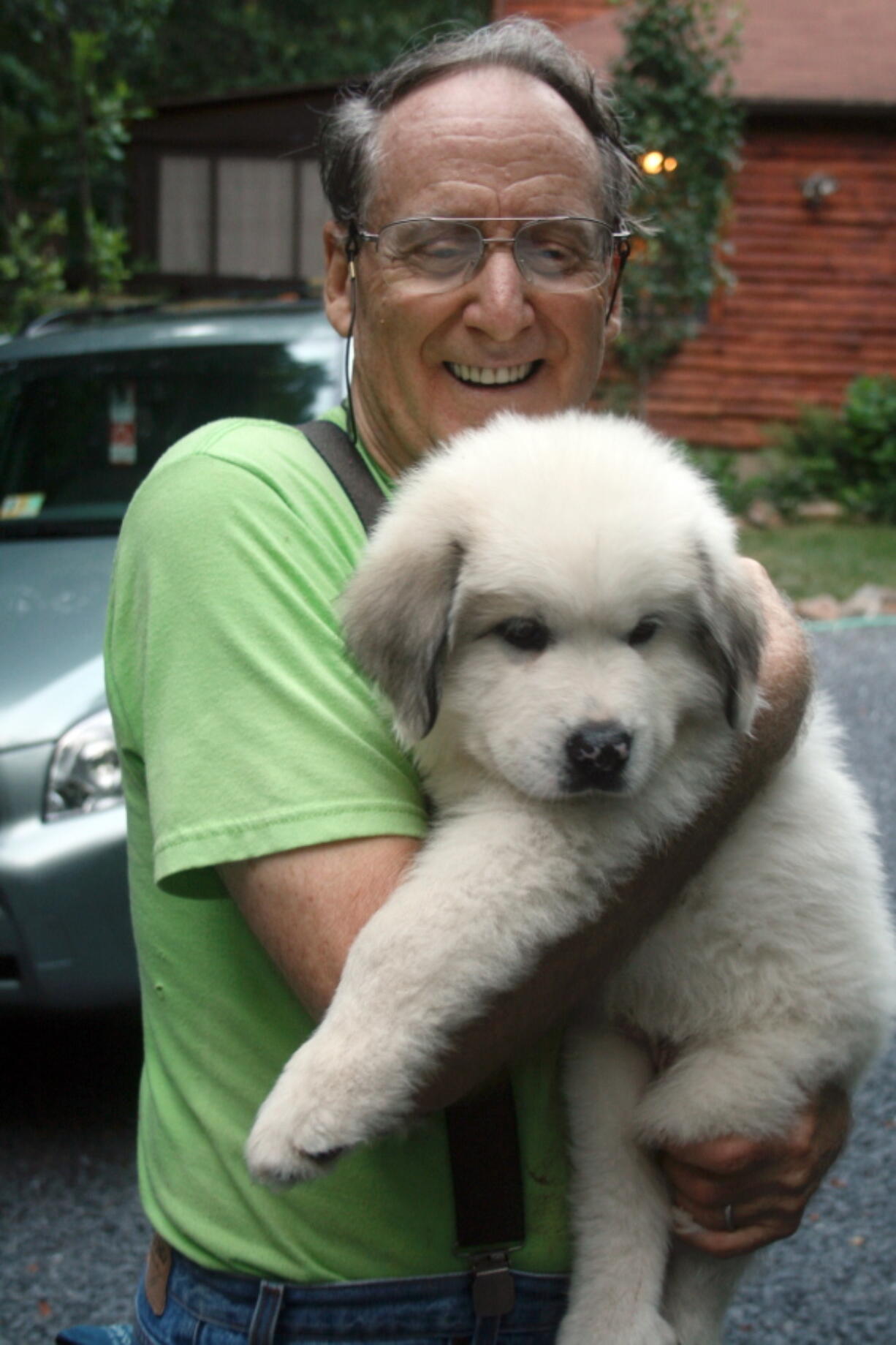 Art Hegeman of rural New Market, Va., holds a Great Pyrenees pup July 8, 2008. The pup eventually grew to 120 pounds and was used as a livestock guardian dog to protect ornamental fowl.