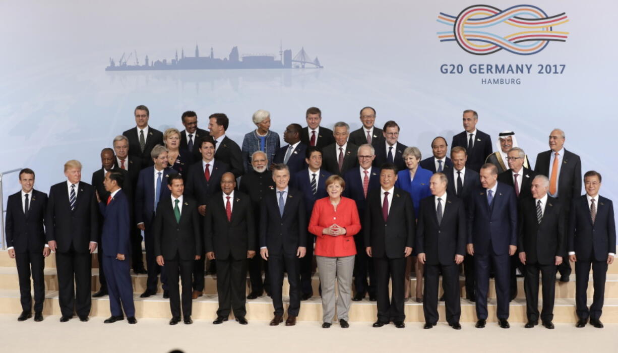 The participants pose for a group photo on the first day of the G-20 summit in Hamburg, northern Germany, on Friday. The leaders of the group of 20 meet July 7 and 8.