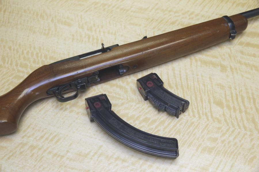 A semi-automatic rifle is displayed with a 25 shot magazine, left, and a 10 shot magazine, right.