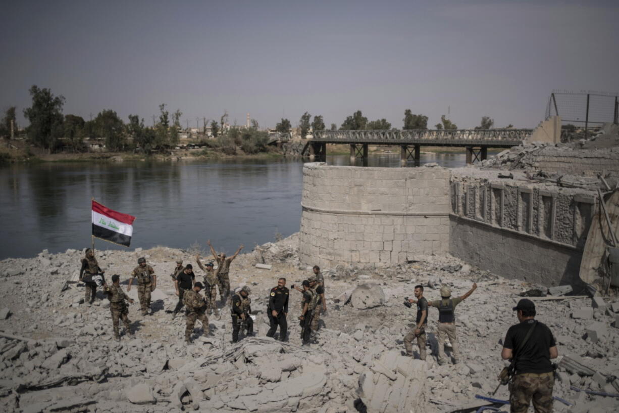 Iraqi Special Forces soldiers celebrate after reaching the bank of the Tigris river as their fight against Islamic State militants continues in parts of the Old City of Mosul, Iraq, Sunday, July 9, 2017.