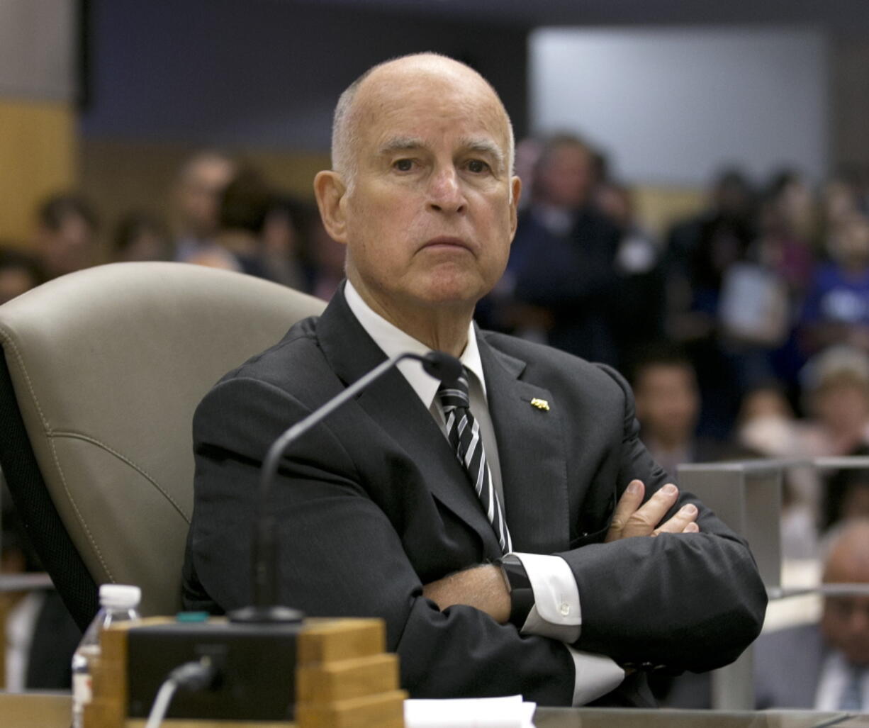 FILE -- In this July 13, 2017 file photo California Gov. Jerry Brown listens as members of the Senate Environmental Quality Committee discuss a pair of climate change bills he supports, in Sacramento, Calif. As his fourth and final term winds down Brown will spend the final 17 months in office working on California’s housing crisis and fighting for ambitious projects to build a high-speed rail system and re-engineer California’s water system.