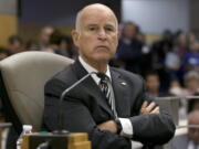 FILE -- In this July 13, 2017 file photo California Gov. Jerry Brown listens as members of the Senate Environmental Quality Committee discuss a pair of climate change bills he supports, in Sacramento, Calif. As his fourth and final term winds down Brown will spend the final 17 months in office working on California’s housing crisis and fighting for ambitious projects to build a high-speed rail system and re-engineer California’s water system.