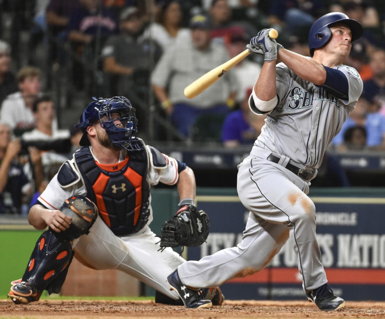 Seattle Mariners’ Kyle Seager watches his go-ahead home run off Houston Astros’ relief pitcher Tony Sipp, in front of catcher Brian McCann during the 10th inning of a baseball game, Monday, July 17, 2017, in Houston.