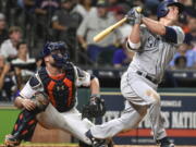 Seattle Mariners’ Kyle Seager watches his go-ahead home run off Houston Astros’ relief pitcher Tony Sipp, in front of catcher Brian McCann during the 10th inning of a baseball game, Monday, July 17, 2017, in Houston.