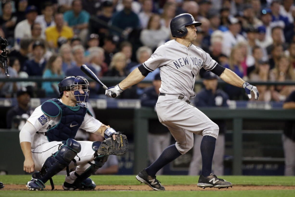 New York Yankees’ Brett Gardner, right, and Seattle Mariners catcher Mike Zunino watch Gardner’s home run during the sixth inning of a baseball game Thursday, July 20, 2017, in Seattle.