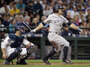 New York Yankees’ Brett Gardner, right, and Seattle Mariners catcher Mike Zunino watch Gardner’s home run during the sixth inning of a baseball game Thursday, July 20, 2017, in Seattle.