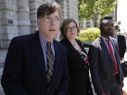 Attorney Andrew Dhuey, from left, representing photographer David Slater, attorney Angela Dunning, representing Blurb, a San Francisco-based self-publishing company, and Trevor Cooper, Legal Counsel at Blurb, speak to reporters outside of the 9th U.S. Circuit Court of Appeals in San Francisco, Wednesday, July 12, 2017. Attorneys for Slater, a wildlife photographer whose camera was used by a monkey to snap selfies, asked a federal appeals court to end a lawsuit seeking to give the animal rights to the photos. People for the Ethical Treatment of Animals sought a court order in 2015 allowing it to administer all proceeds from the photos to benefit the monkey.