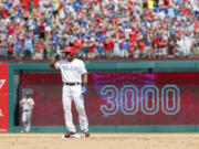 Texas Rangers’ Adrian Beltre tips his helmet as he acknowledges cheers after hitting a double for his 3,000th career hit that came off a pitch from Baltimore Orioles’ Wade Miley in the fourth inning of a baseball game, Sunday, July 30, 2017, in Arlington, Texas.