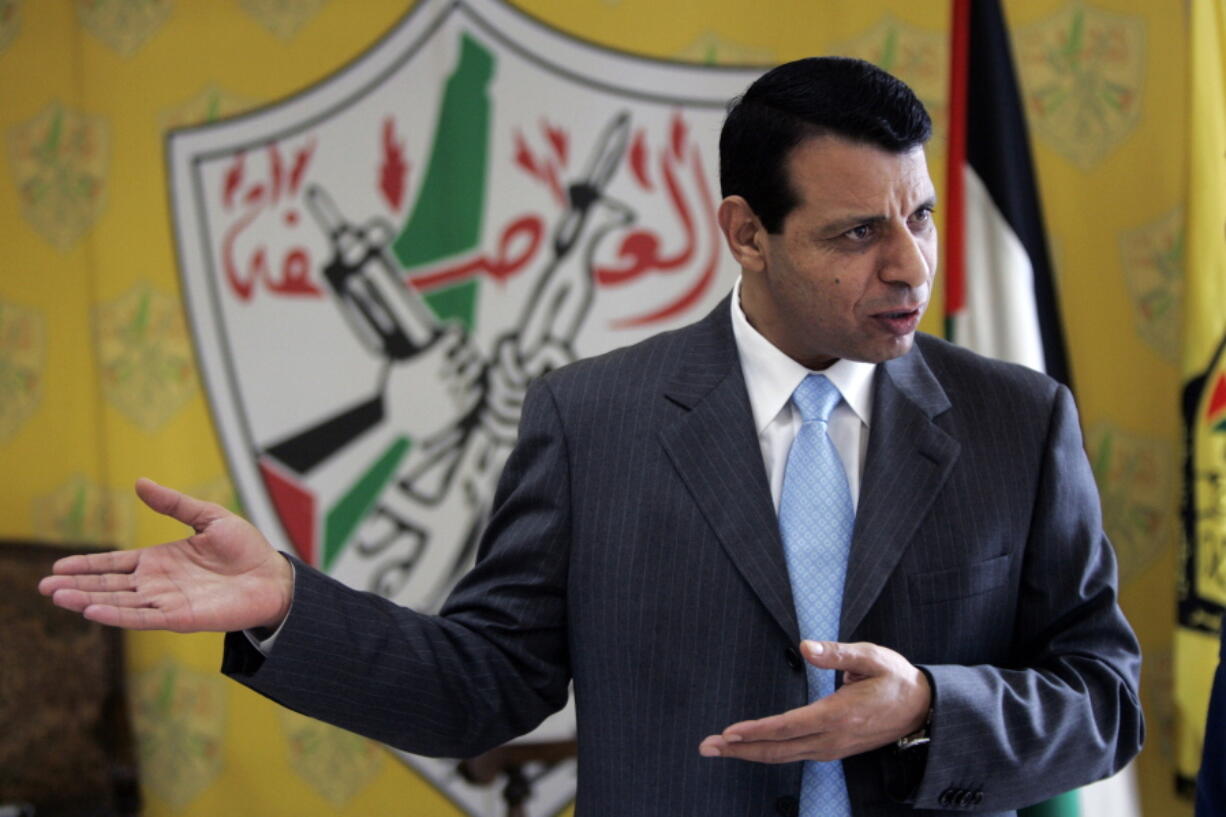 File - In this Jan. 3, 2011 file photo, then Palestinian Fatah leader Mohammed Dahlan gestures as he speaks during an interview with The Associated Press in his office in the West Bank city of Ramallah. The exiled Palestinian politician who quietly negotiated a power-sharing deal for Gaza with former arch foe Hamas discussed the details for the first time in an interview, saying he expects the understandings to lead to a swift opening of the blockaded territory’s border with Egypt and ease crippling power shortages.