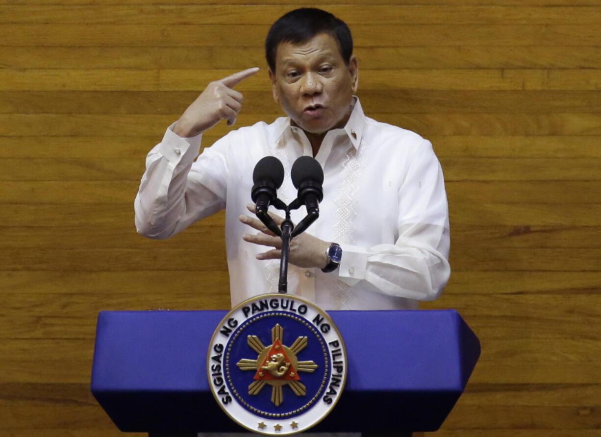 Philippine President Rodrigo Duterte gestures during his second state of the nation address at the House of Representatives in suburban Quezon city, north of Manila, Philippines, Monday July 24, 2017. Duterte said he will not stop his deadly crackdown on illegal drugs and warns that addicts and dealers have two choices: jail or hell.