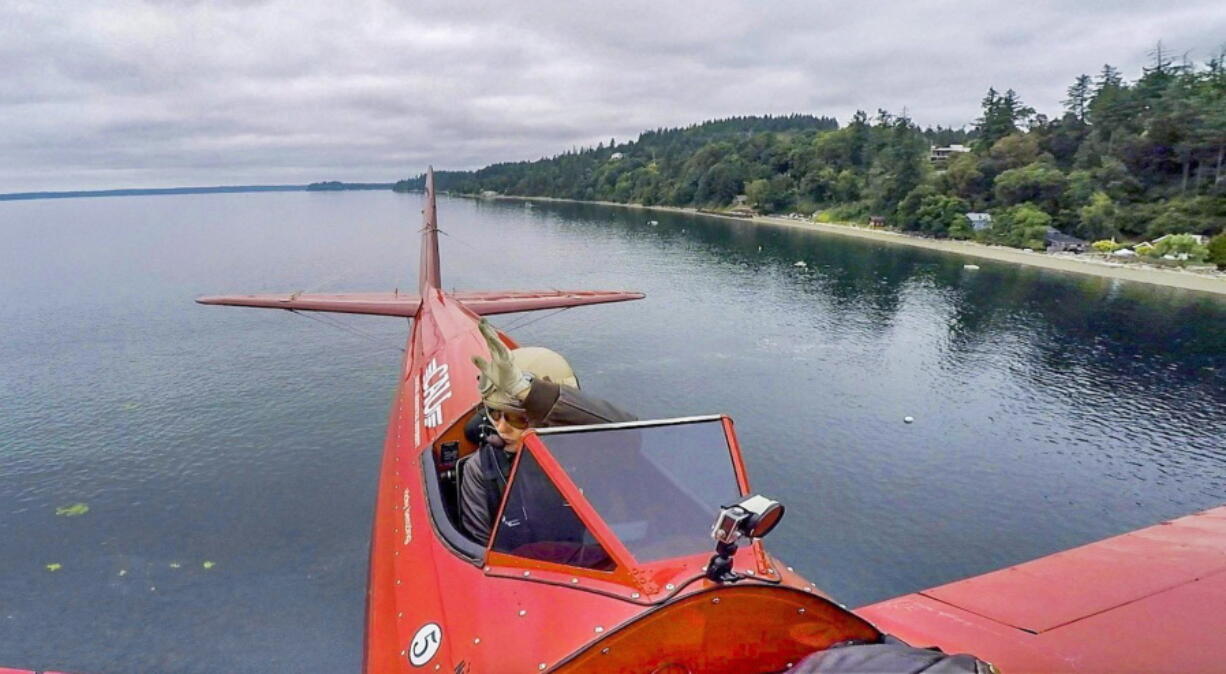 Stunt pilot Vicky Benzing flys her 1940 Boeing Stearman biplane low July 3 along the Fox Island shore. From reaching speeds of nearly 470 miles per hour in a jet to skydiving or performing aerobatics, Benzing is at home in the sky.