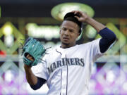 Seattle Mariners starting pitcher Ariel Miranda takes a moment to tug on his cap against the Kansas City Royals in a baseball game Wednesday, July 5, 2017, in Seattle.